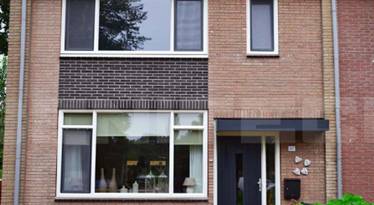 Voorgevel huis twee onder een kap woning met kunststof kozijnen, ramen en deuren