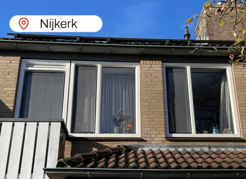 Gevel bovenverdieping met witte kunststof kozijnen